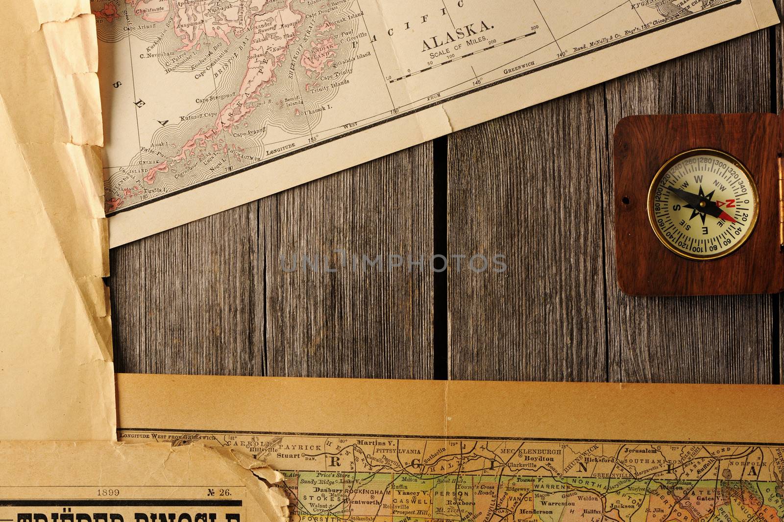 Antique wooden compass over old map