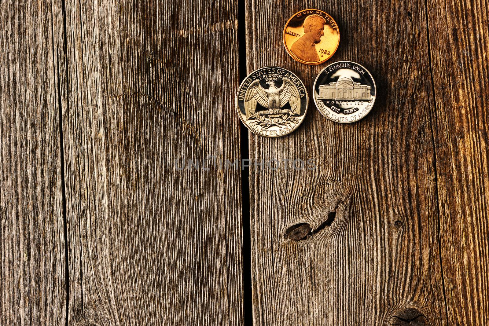 Three US cent coins over wooden background
