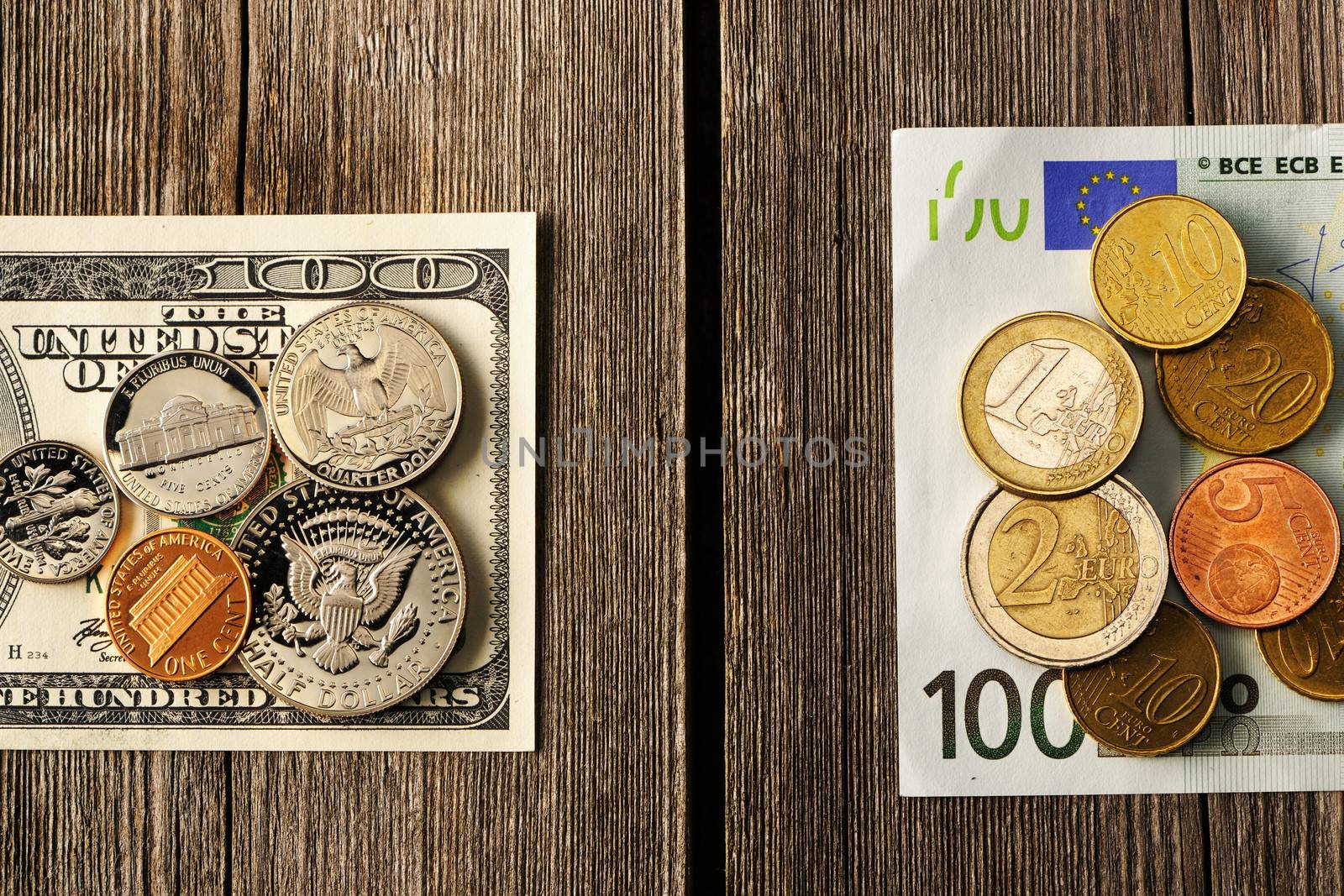 US and euro currency over wooden background