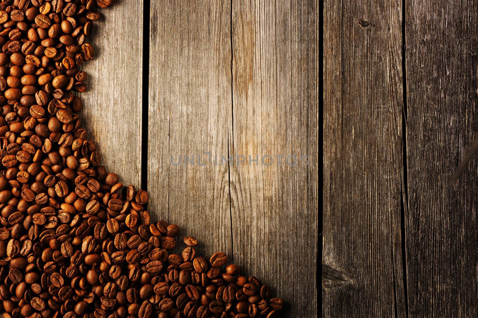 Coffee beans over wooden background