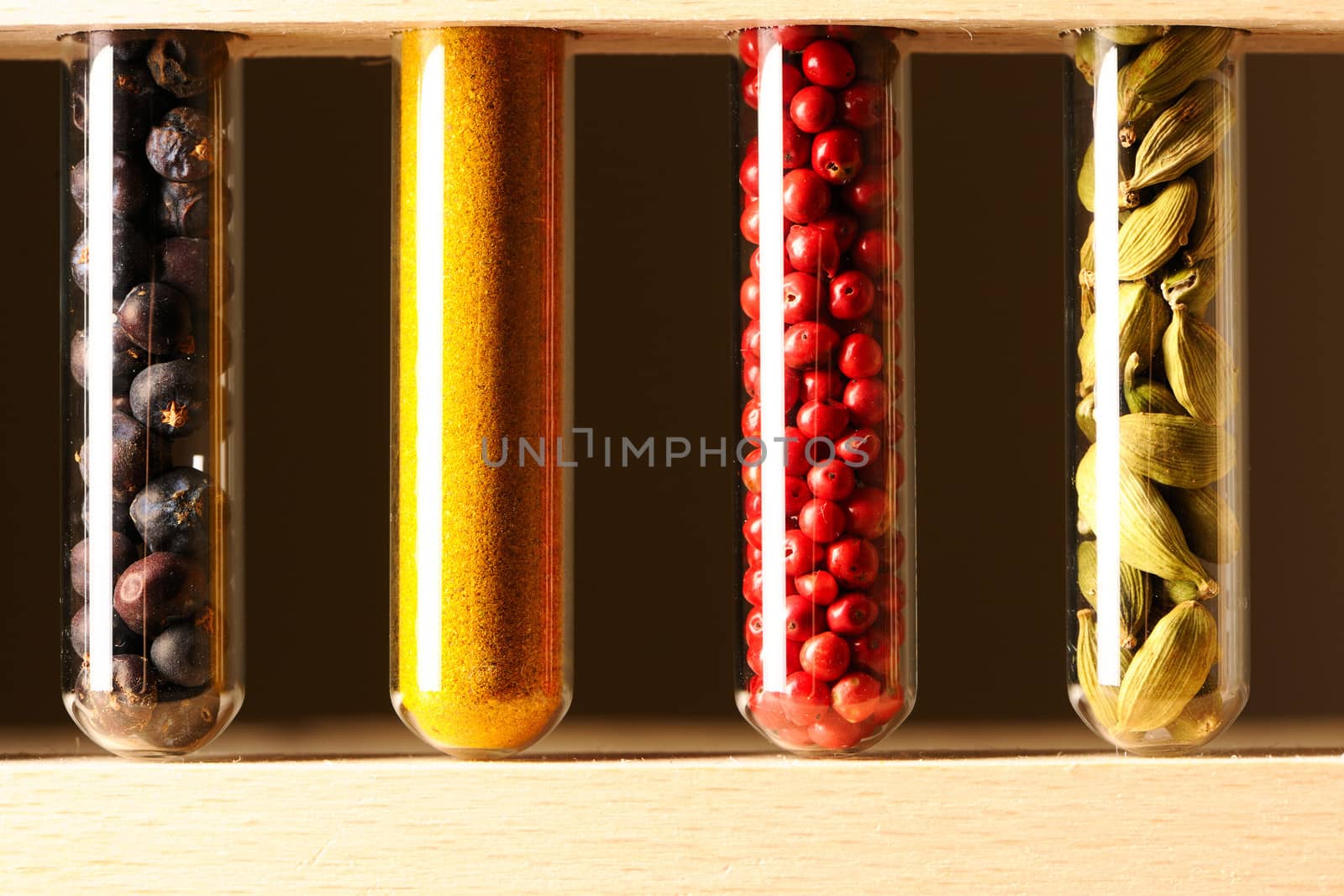 Spices in beakers against dark background