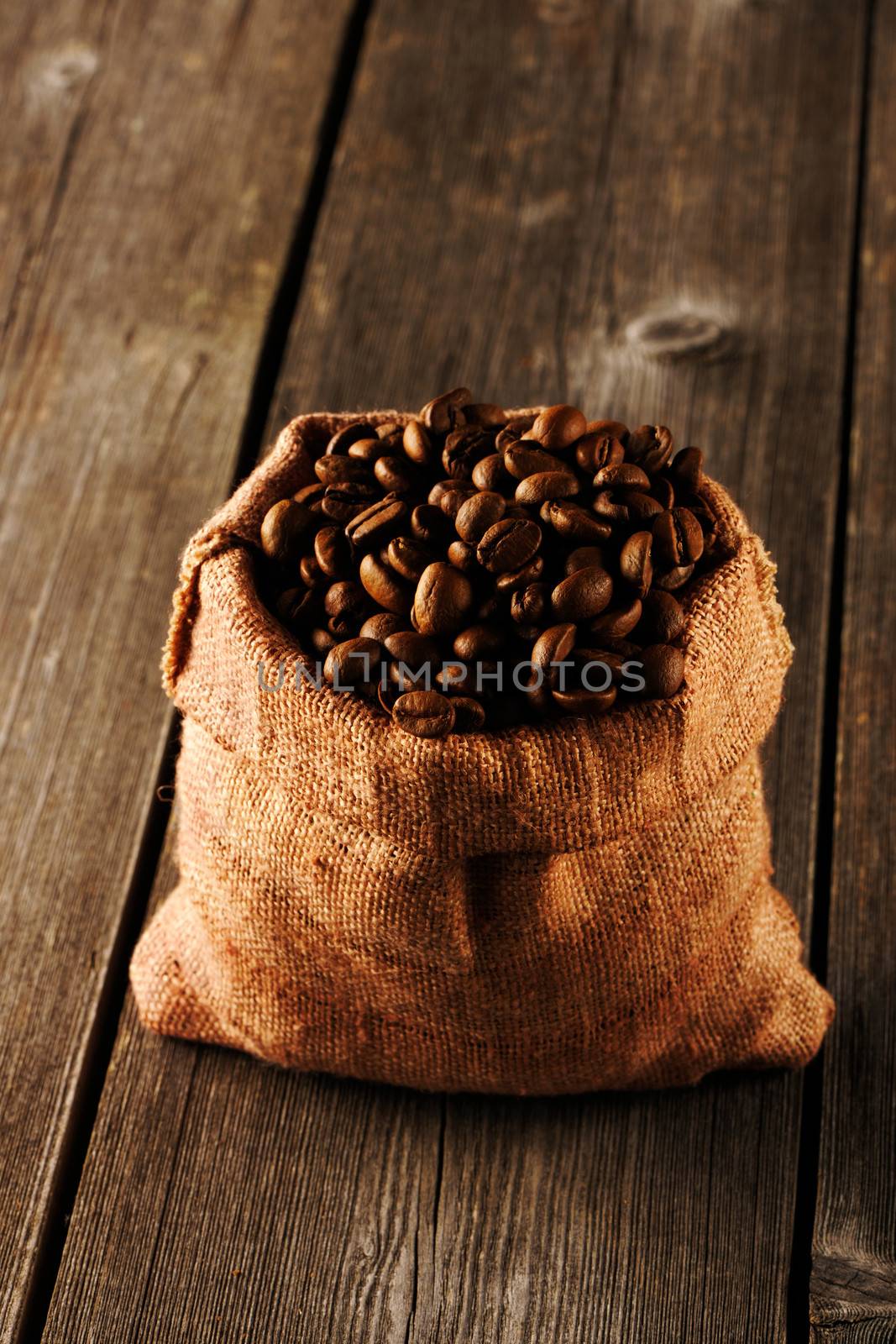 Coffee beans in bag on wooden table