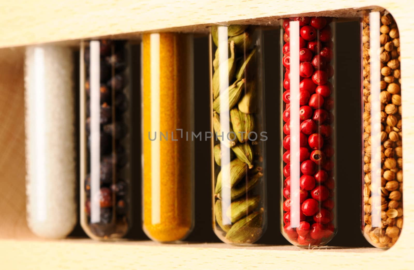 Spices in beakers against dark background