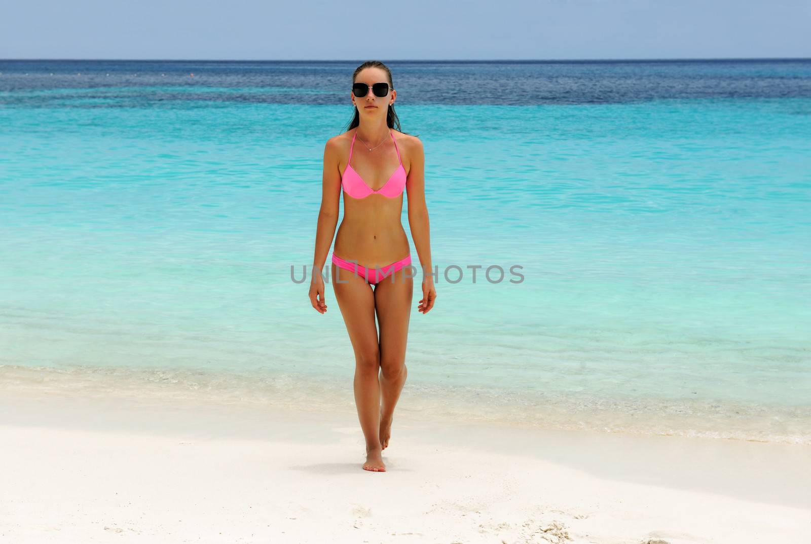 Woman in bikini at tropical beach