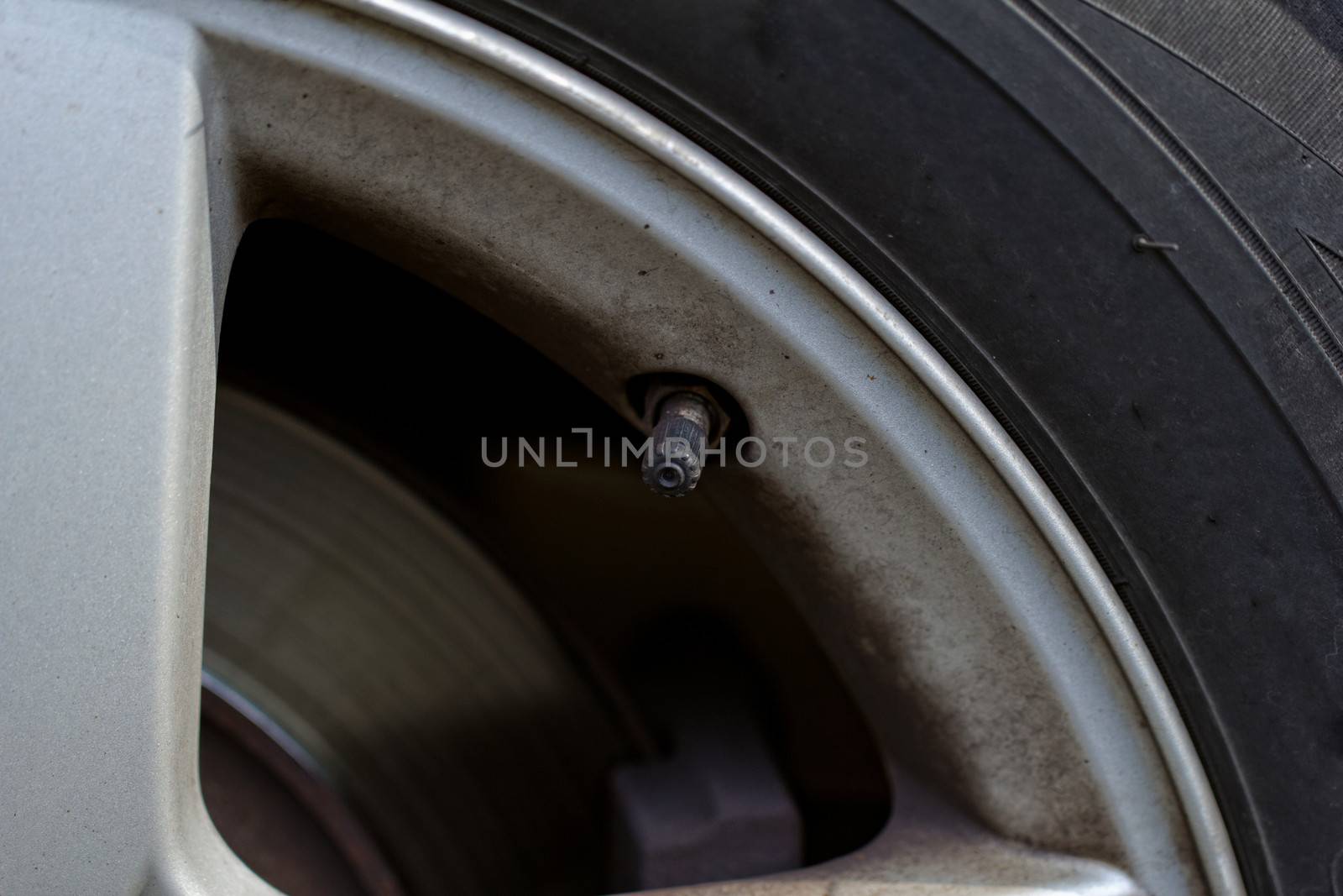 close up tire valve on the rim of a luxury sports car 