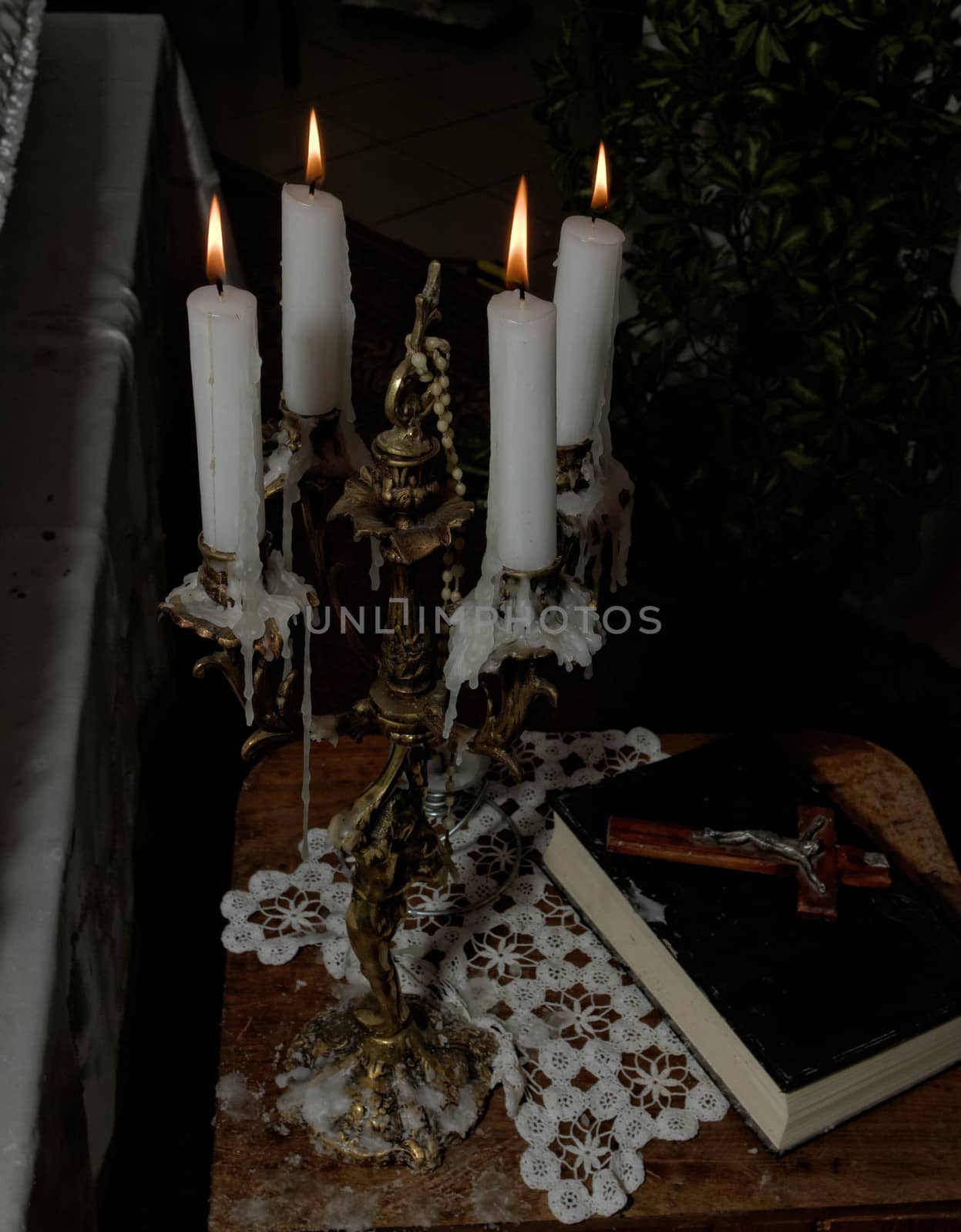 burning candle with holy bible