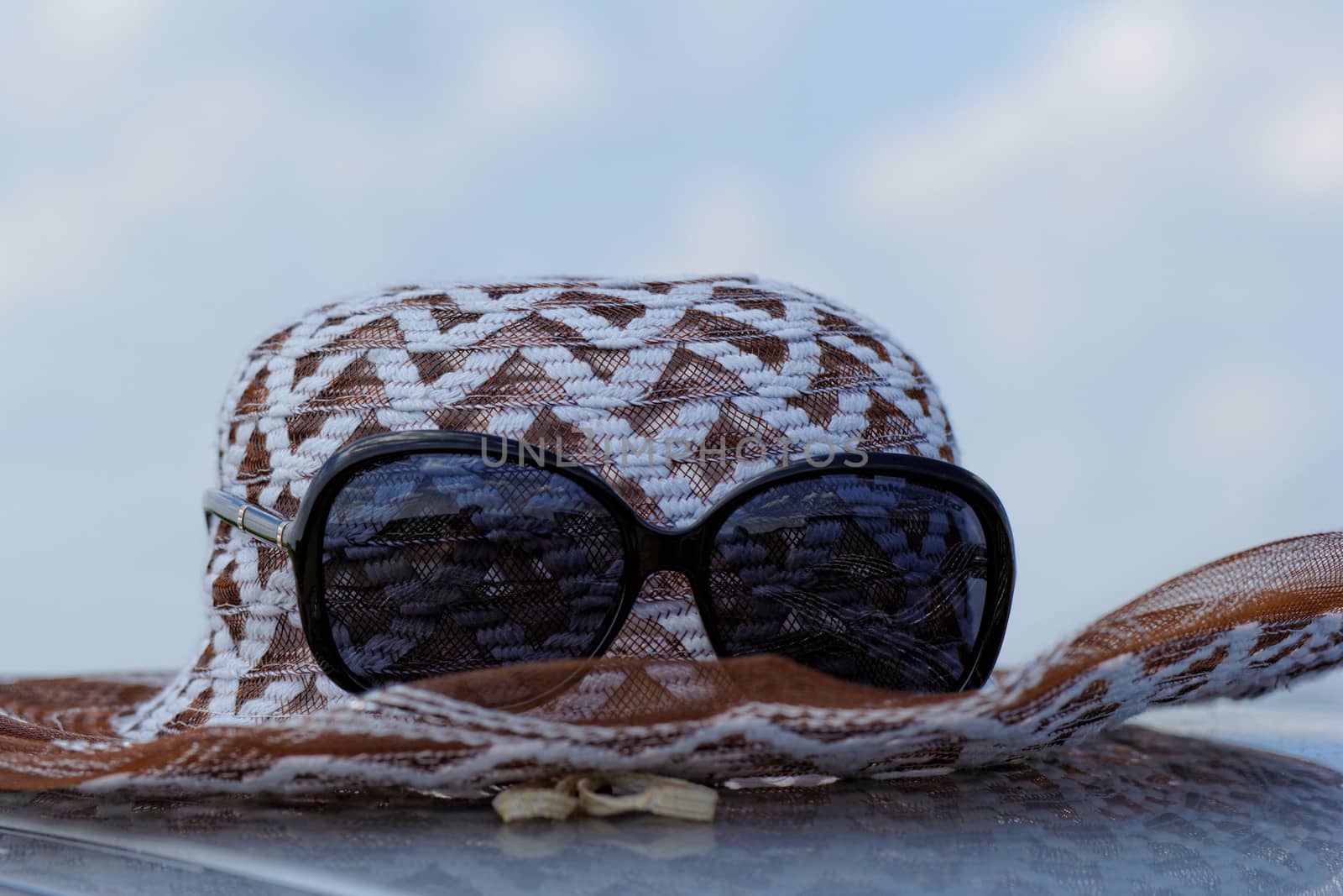 hat with sunglasses under the sky