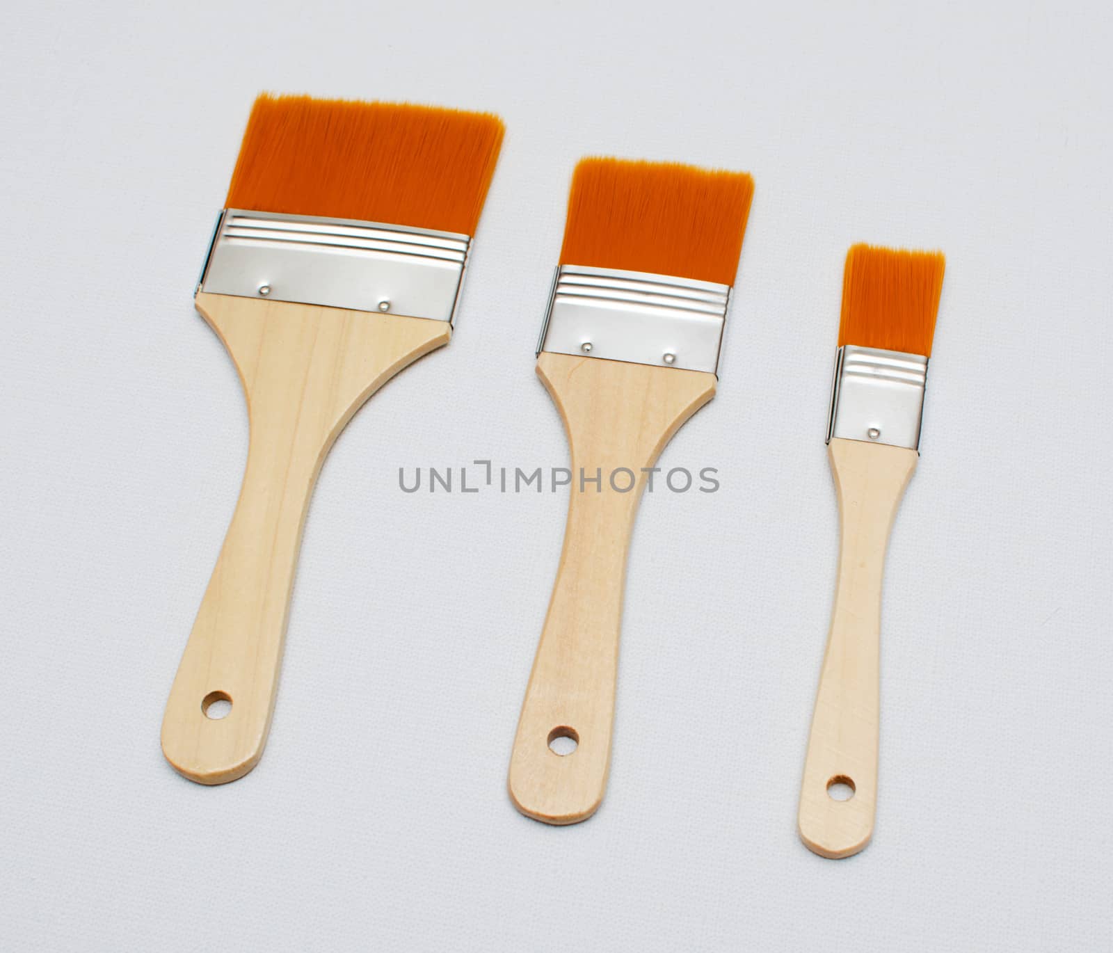 new paint brushes on canvas background by DNKSTUDIO