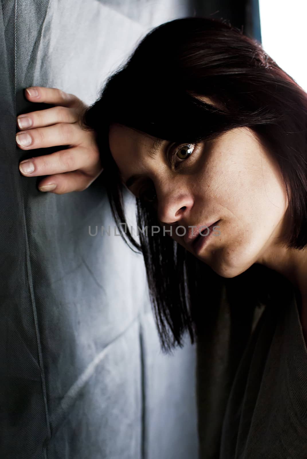 conceptual portrait of stressed abused young woman 