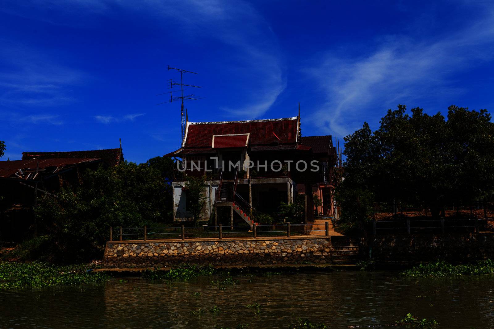 Thai traditional house along the river, Living with natural take photo from river.