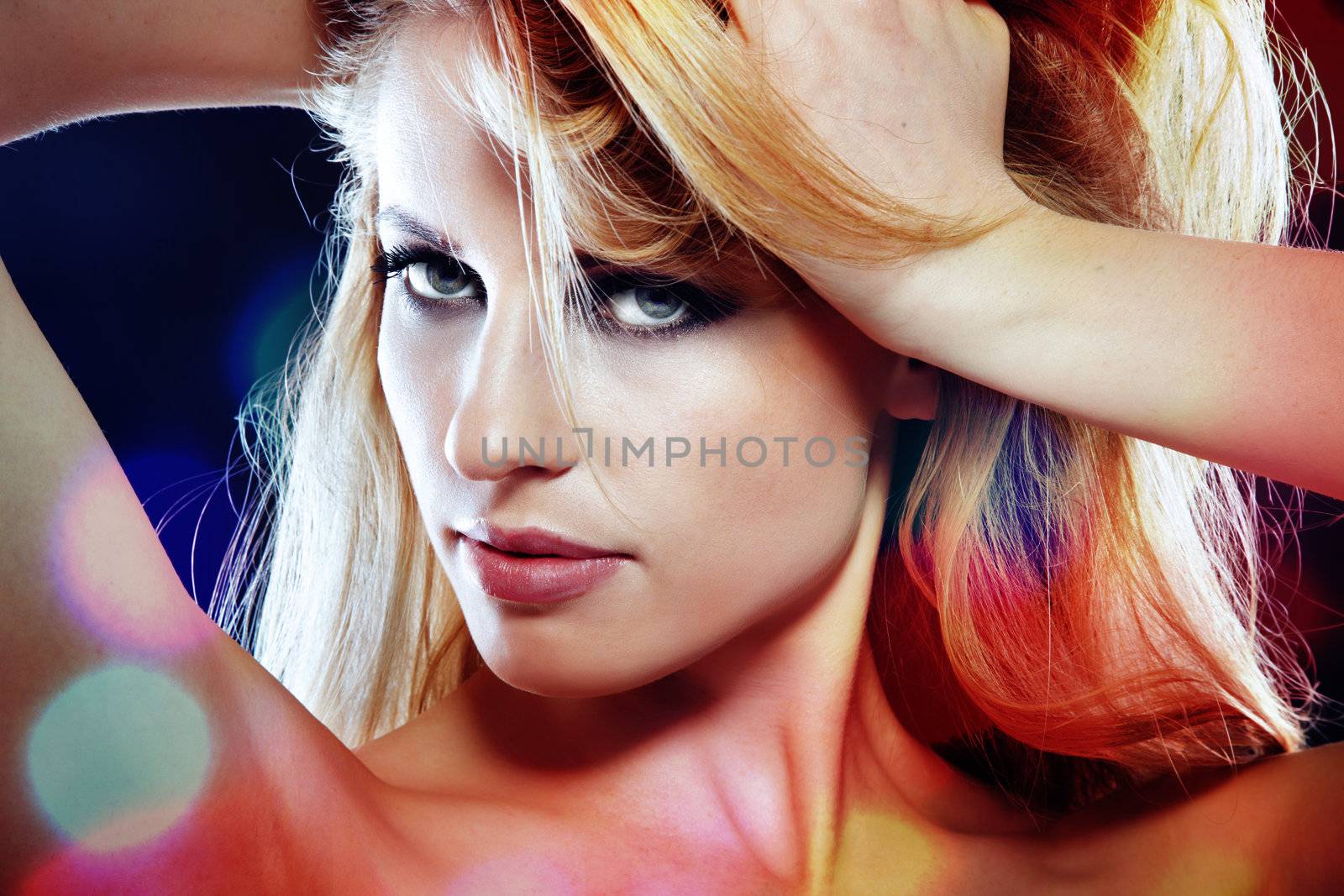 Sexy lady in the disco nightclub with spotlight illuminated on her skin. Horizontal photo with vibrant color