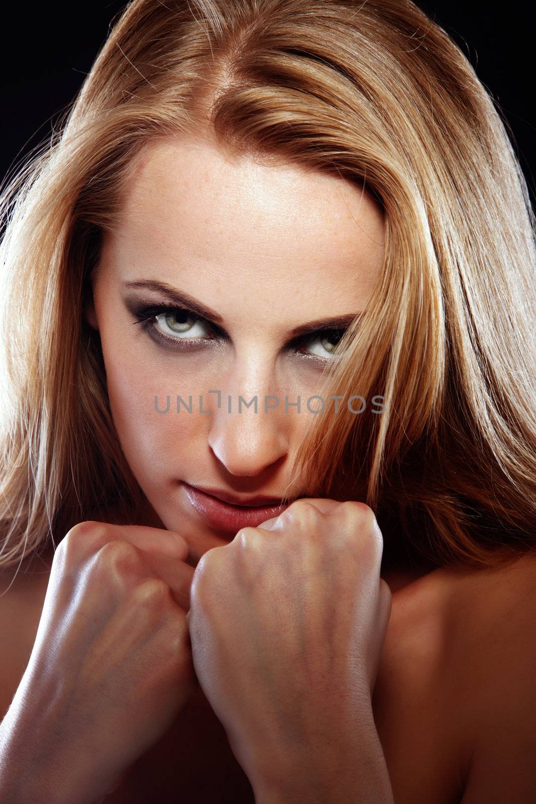 Beautiful lady with clinched fists protecting herself as a symbol of woman's right