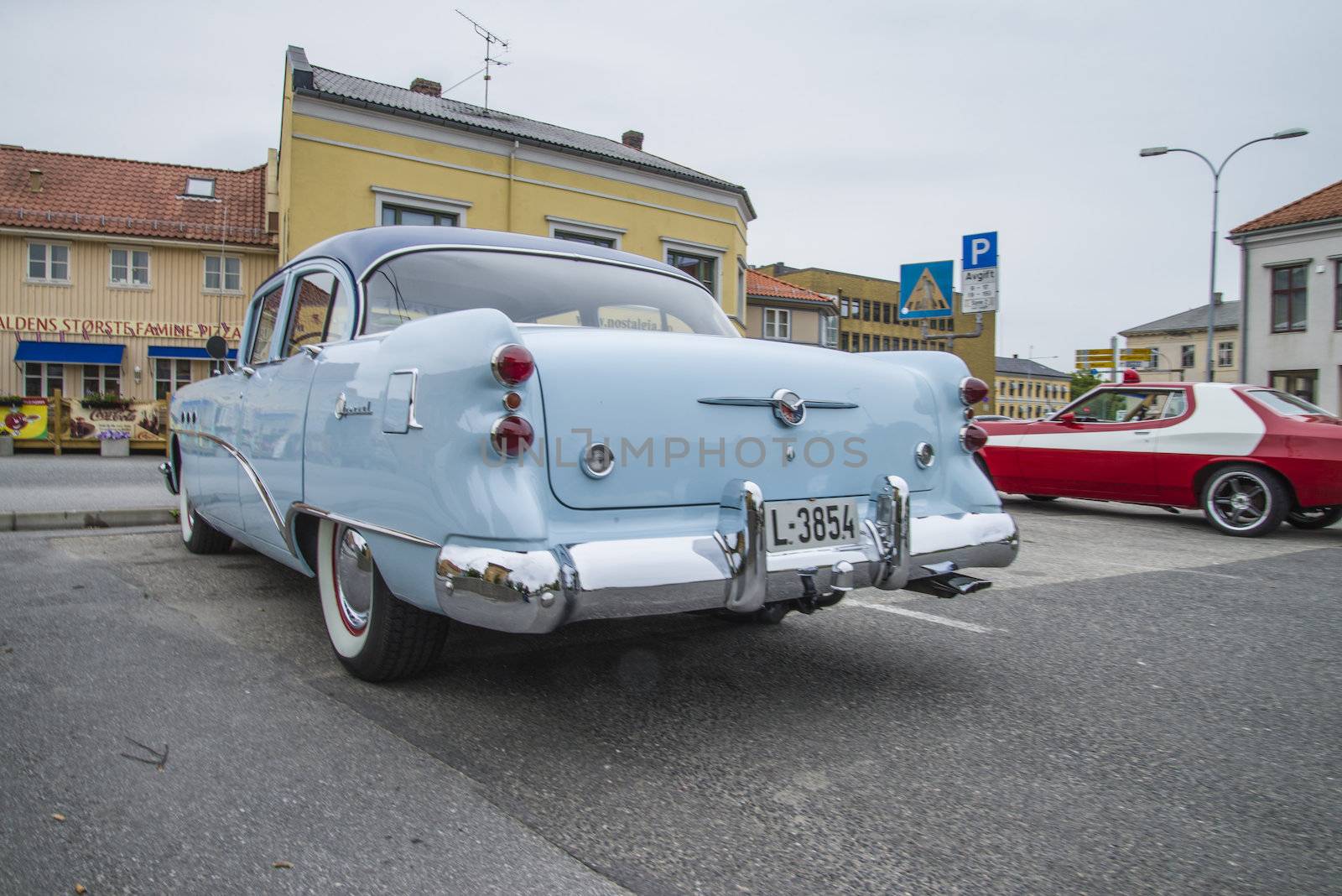 The image is shot at a fish-market in Halden, Norway where there every Wednesday during the summer months are held classic American car show.