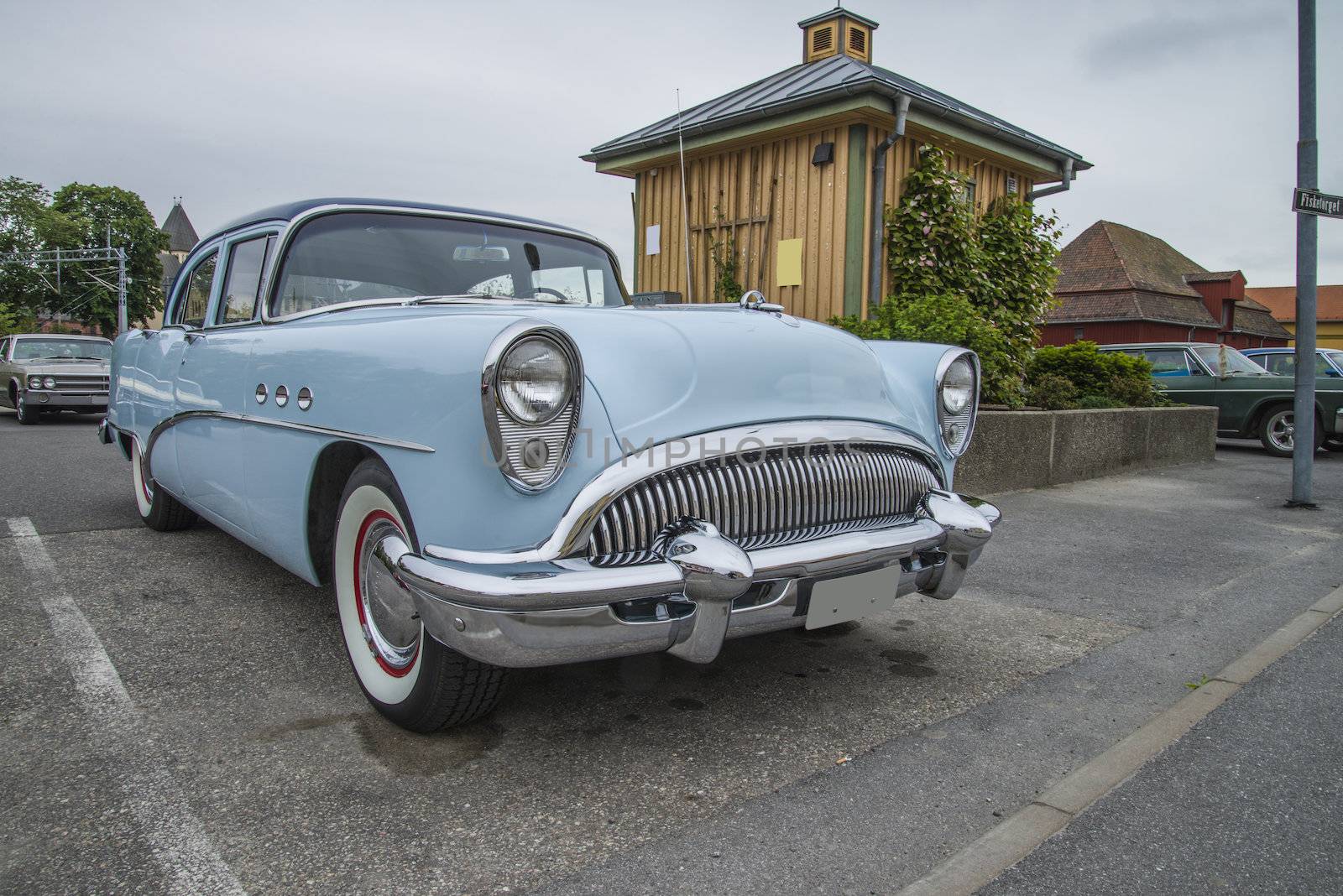 The image is shot at a fish-market in Halden, Norway where there every Wednesday during the summer months are held classic American car show.