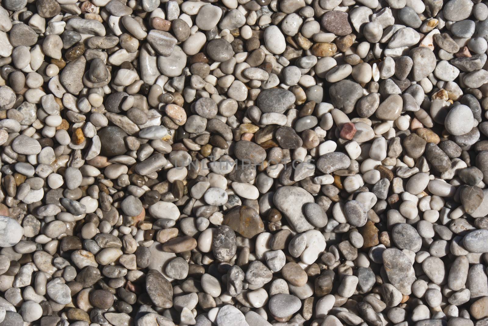 All rounded tiny pebbles from beach, a natural background