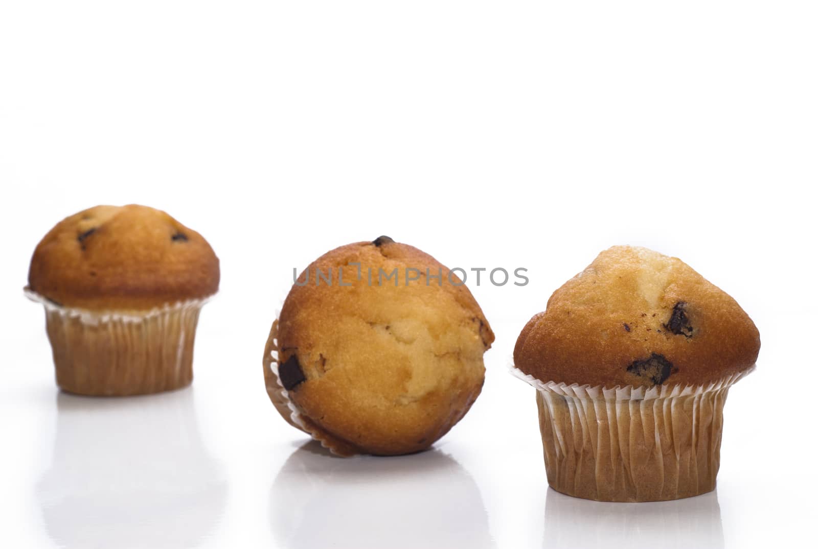 sweet muffins with chocolate drops isolated on a white background