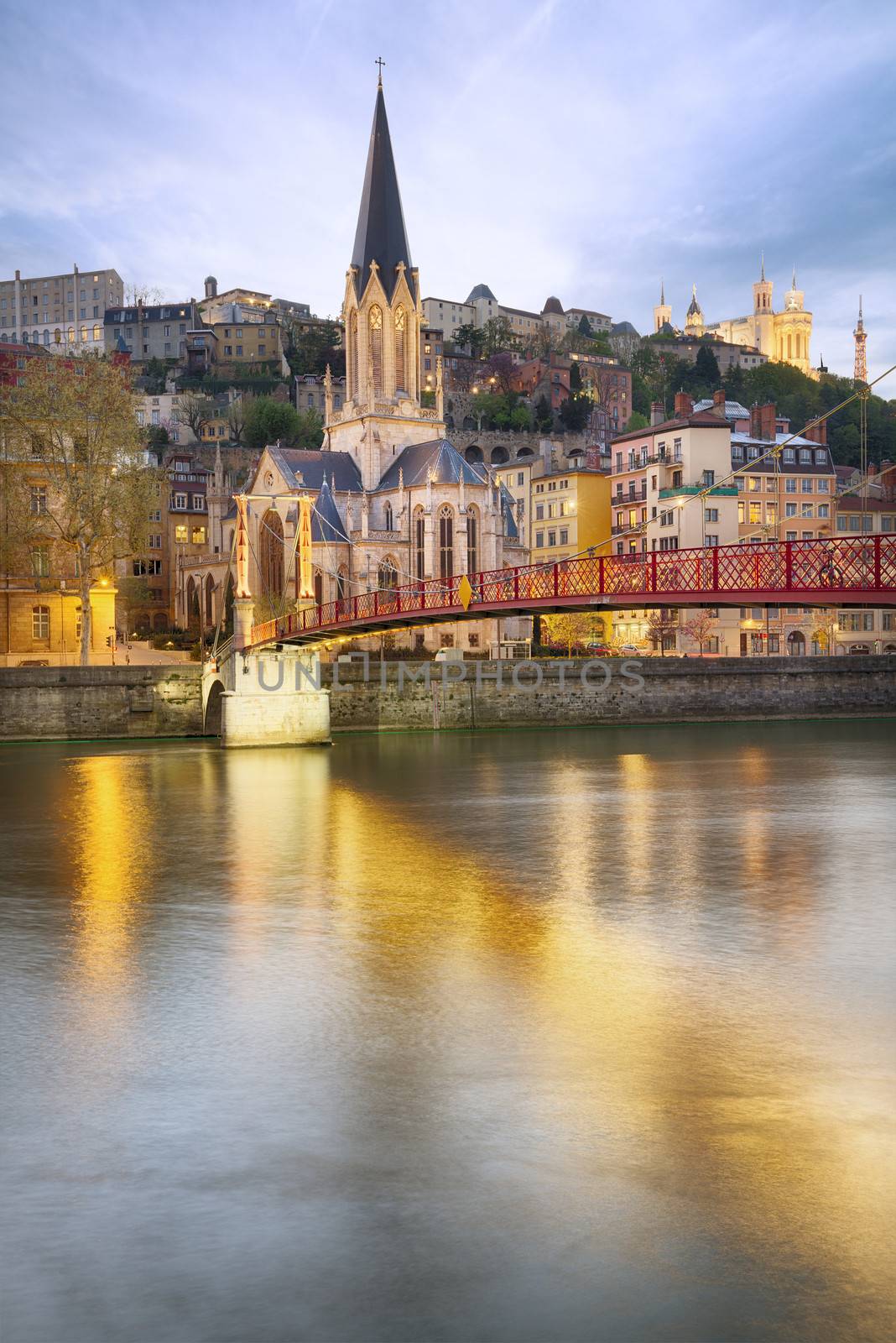 night view from St Georges footbridge in Lyon city with Fourviere cathedral, France