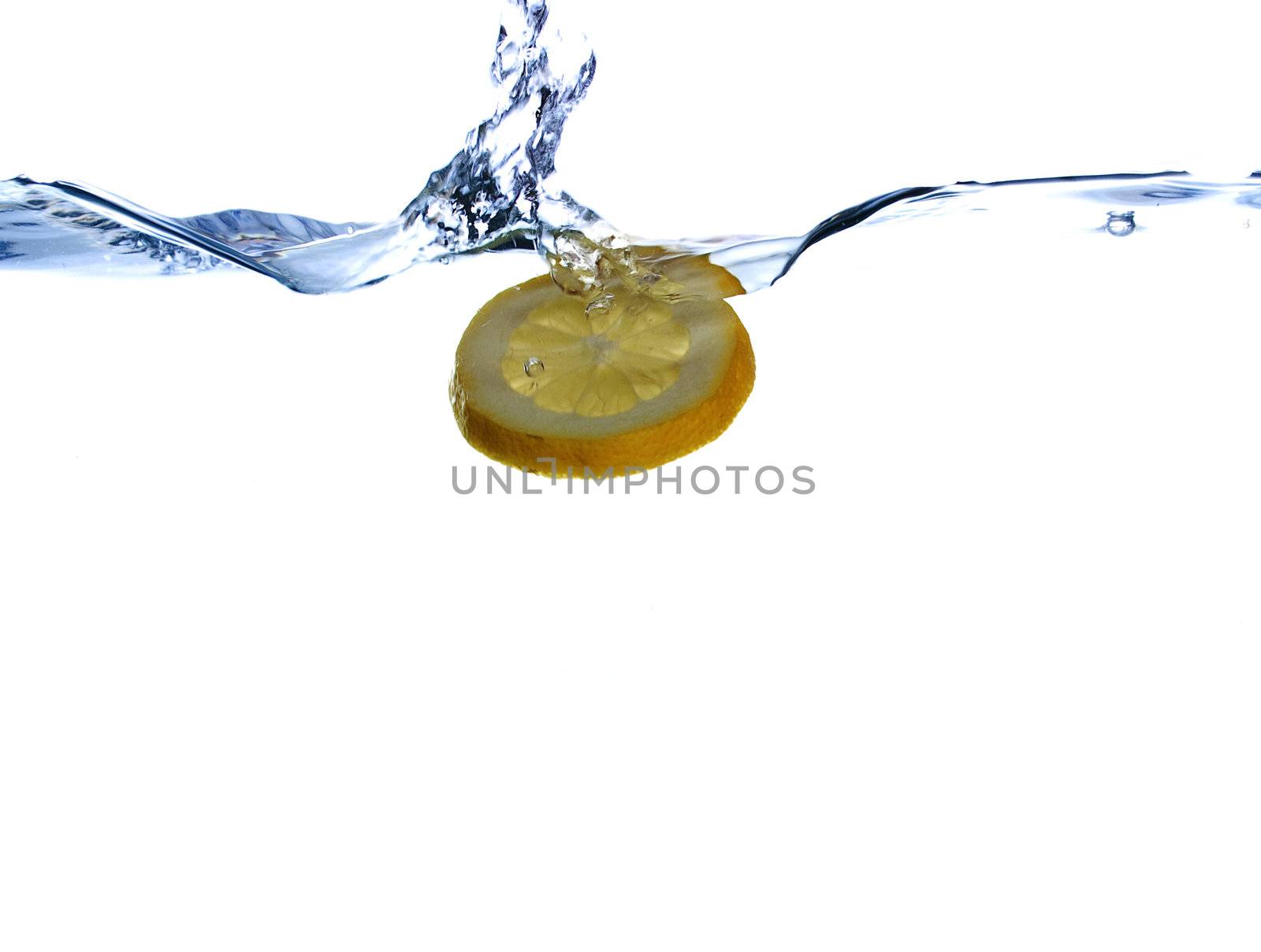 Lemon in the flight surrounded and followed by water bubbles