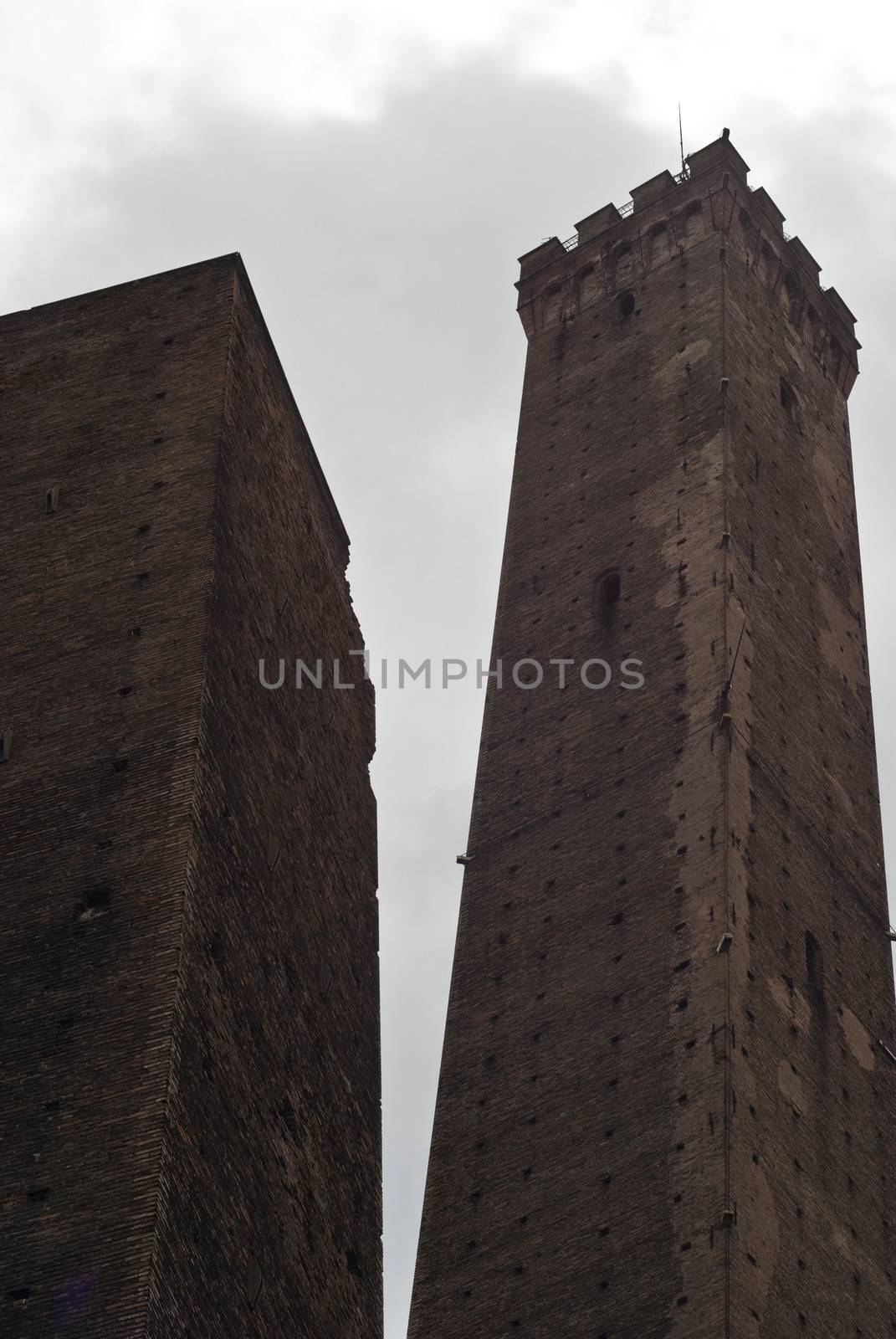 Due Torri - symbol of city under cloudy sky in Bologna, Italy