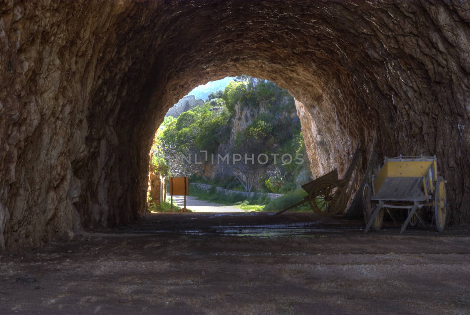 Natural cave in the Zingaro reserve. inside the cave ancient Sicilian carts