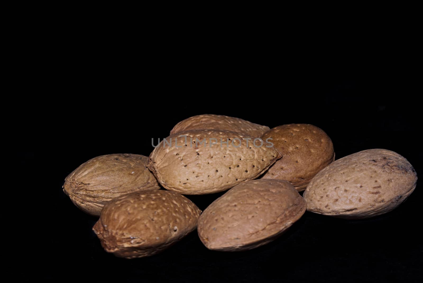 almonds isolated on a black background