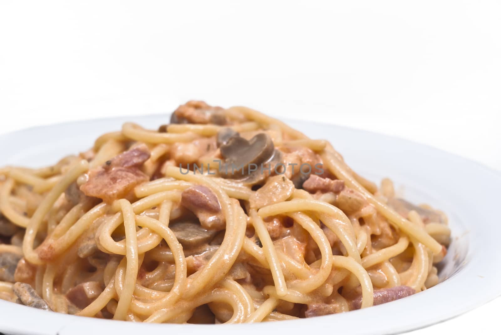 spaghetti pasta with mushrooms sauce isolated on white background