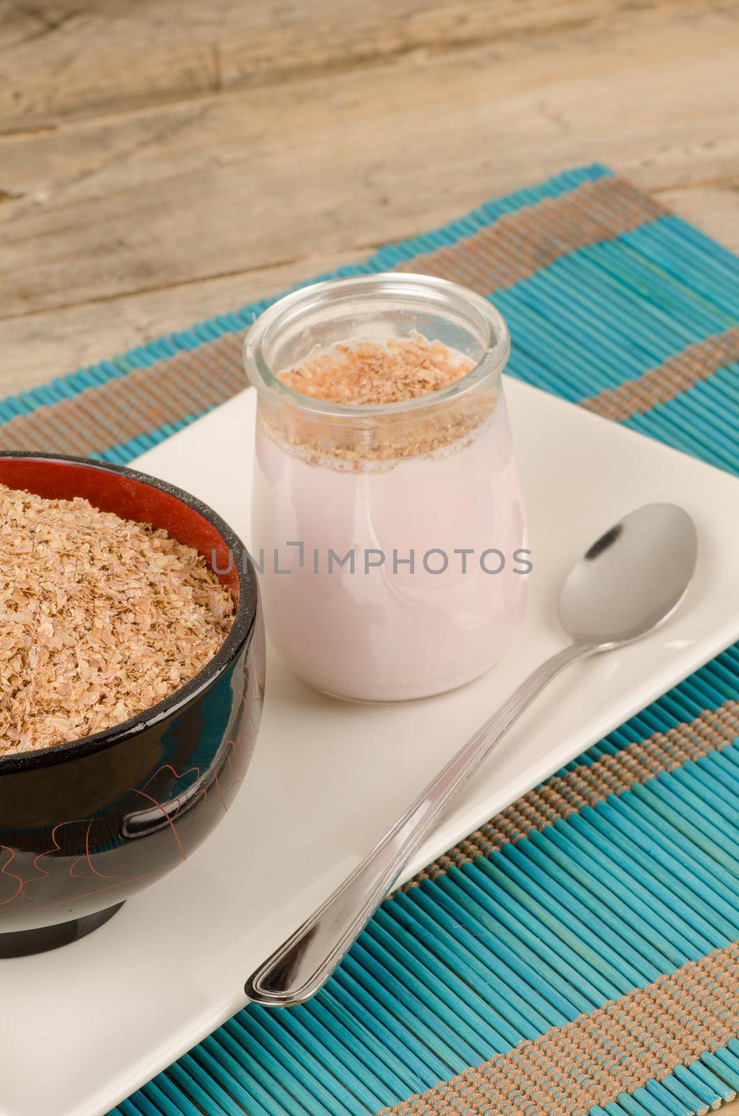 Homemade yoghurt served with bran, a healthy breakfast