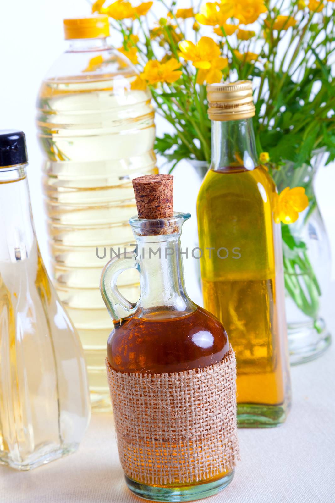 bottles of oil with buttercup by motorolka