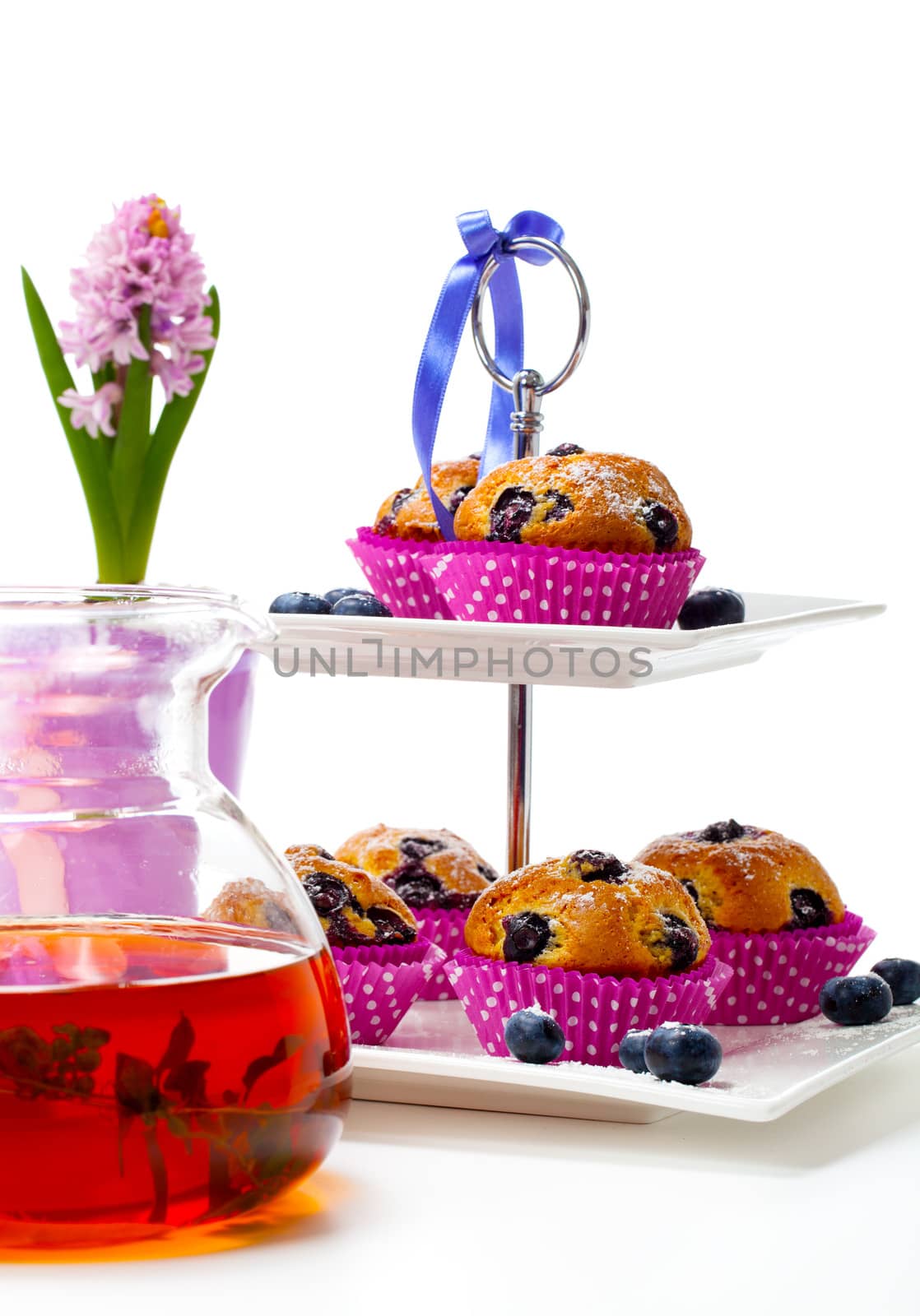 Blueberry muffins on white background by motorolka