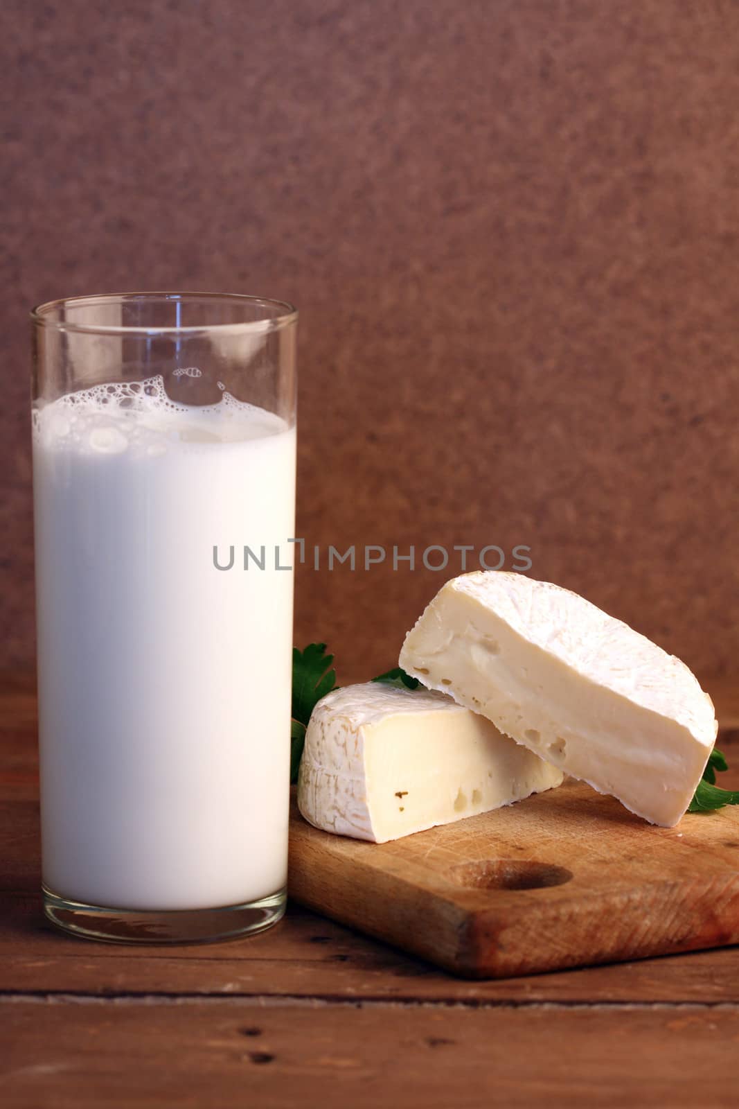 soft camembert cheese with a glass of milk