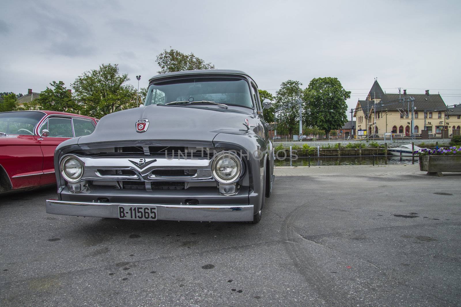 The image is shot at a fish-market in Halden, Norway where there every Wednesday during the summer months are held classic American car show.