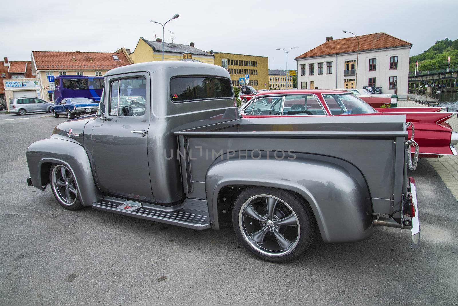 The image is shot at a fish-market in Halden, Norway where there every Wednesday during the summer months are held classic American car show.