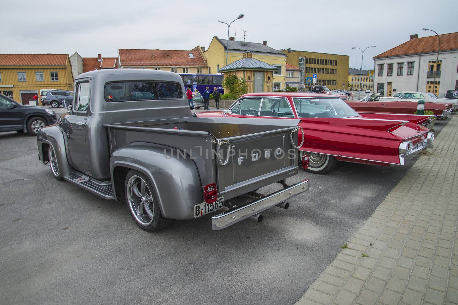 The image is shot at a fish-market in Halden, Norway where there every Wednesday during the summer months are held classic American car show.