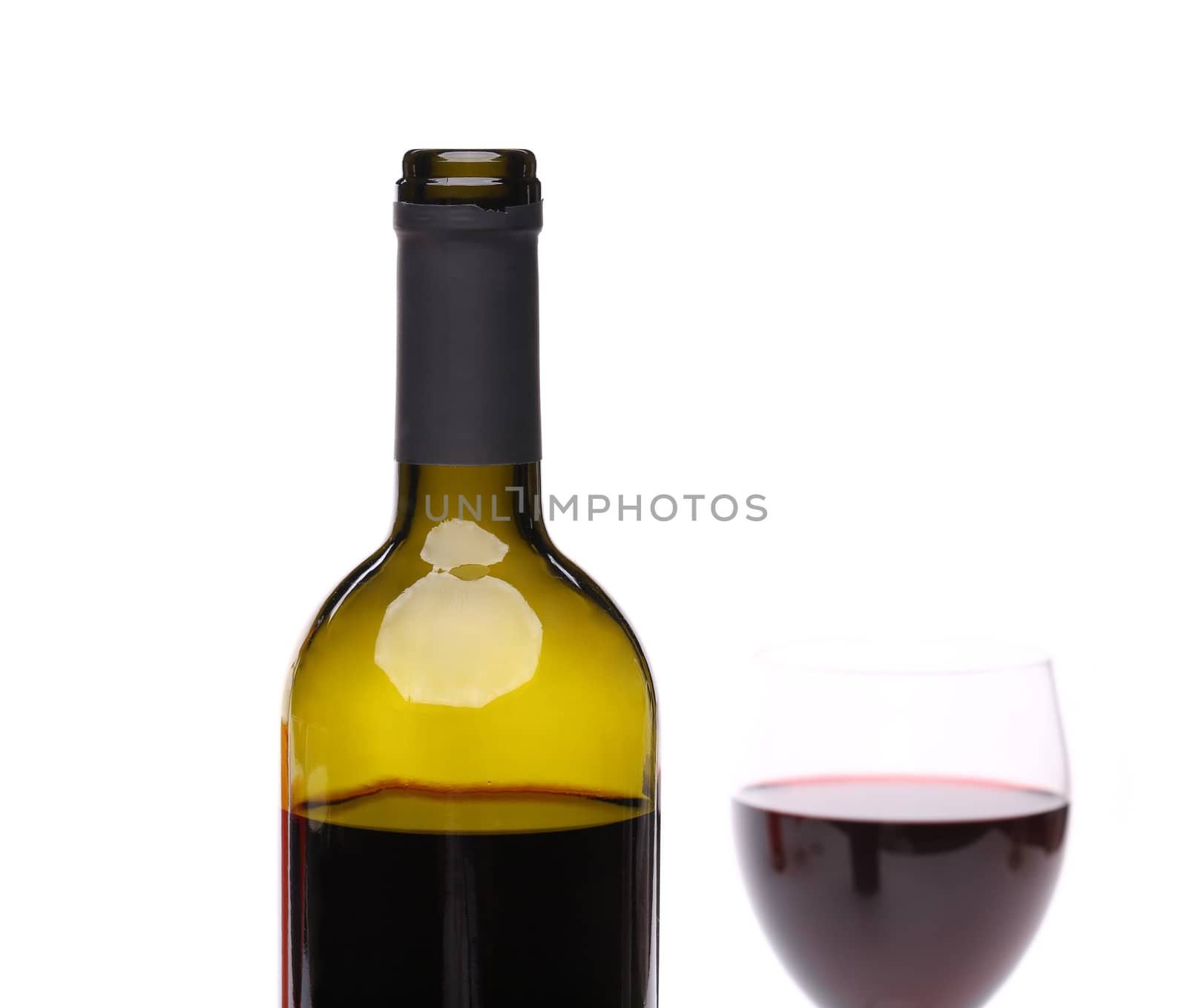 A bottle of red wine and filled with the same level of a wine glass on a white background