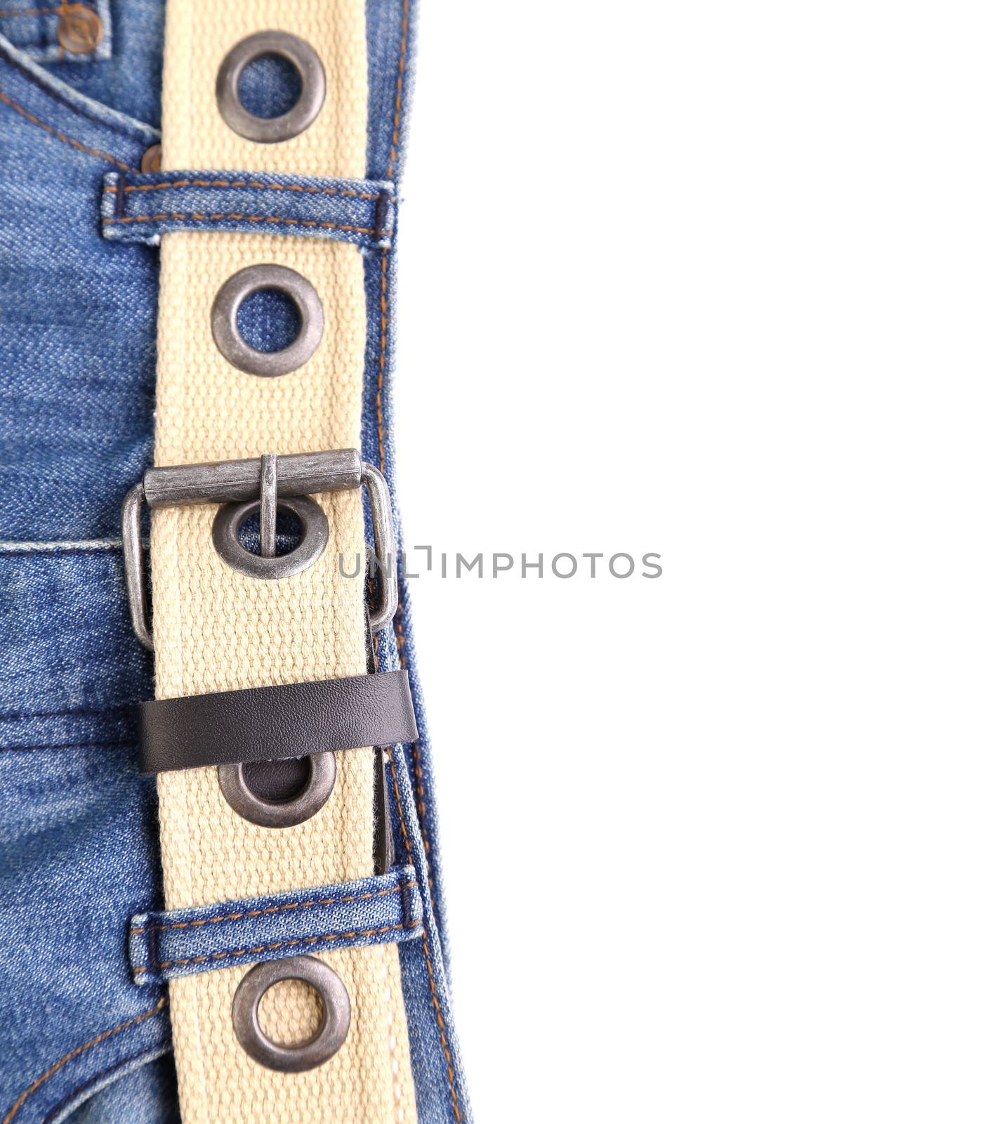Blue jeans and leather belt are located left on the white background