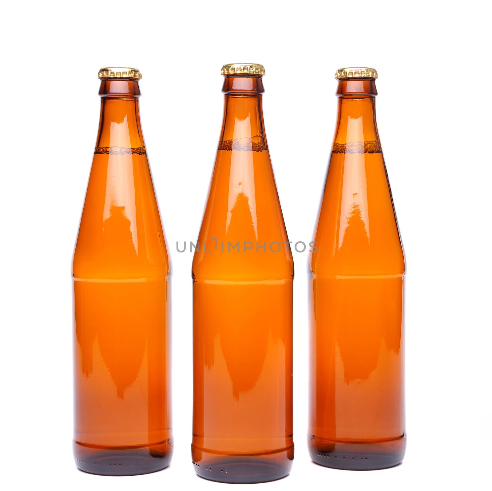 Three brown beer bottle with drops drink without label on a white background