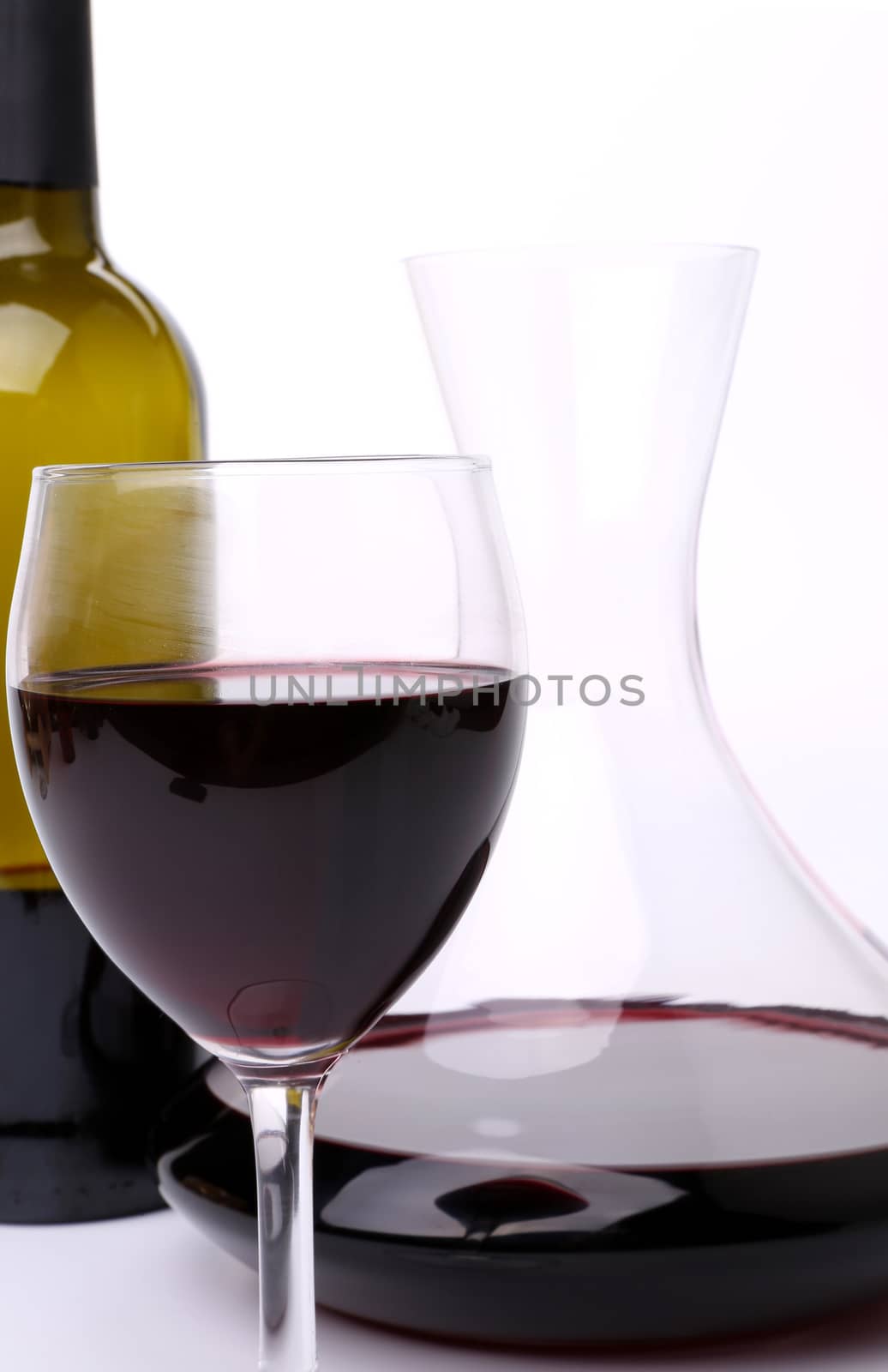 Decanter, bottle and glass of wine close-up by indigolotos
