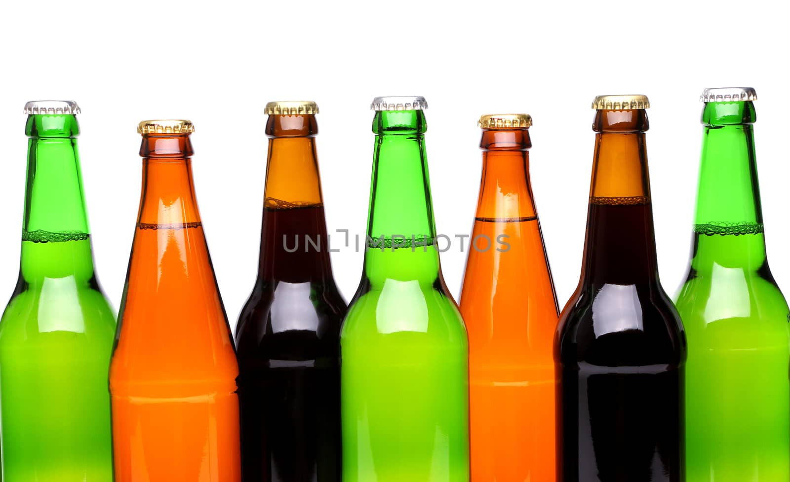 A row of top beer bottles on a white background with a reflection.