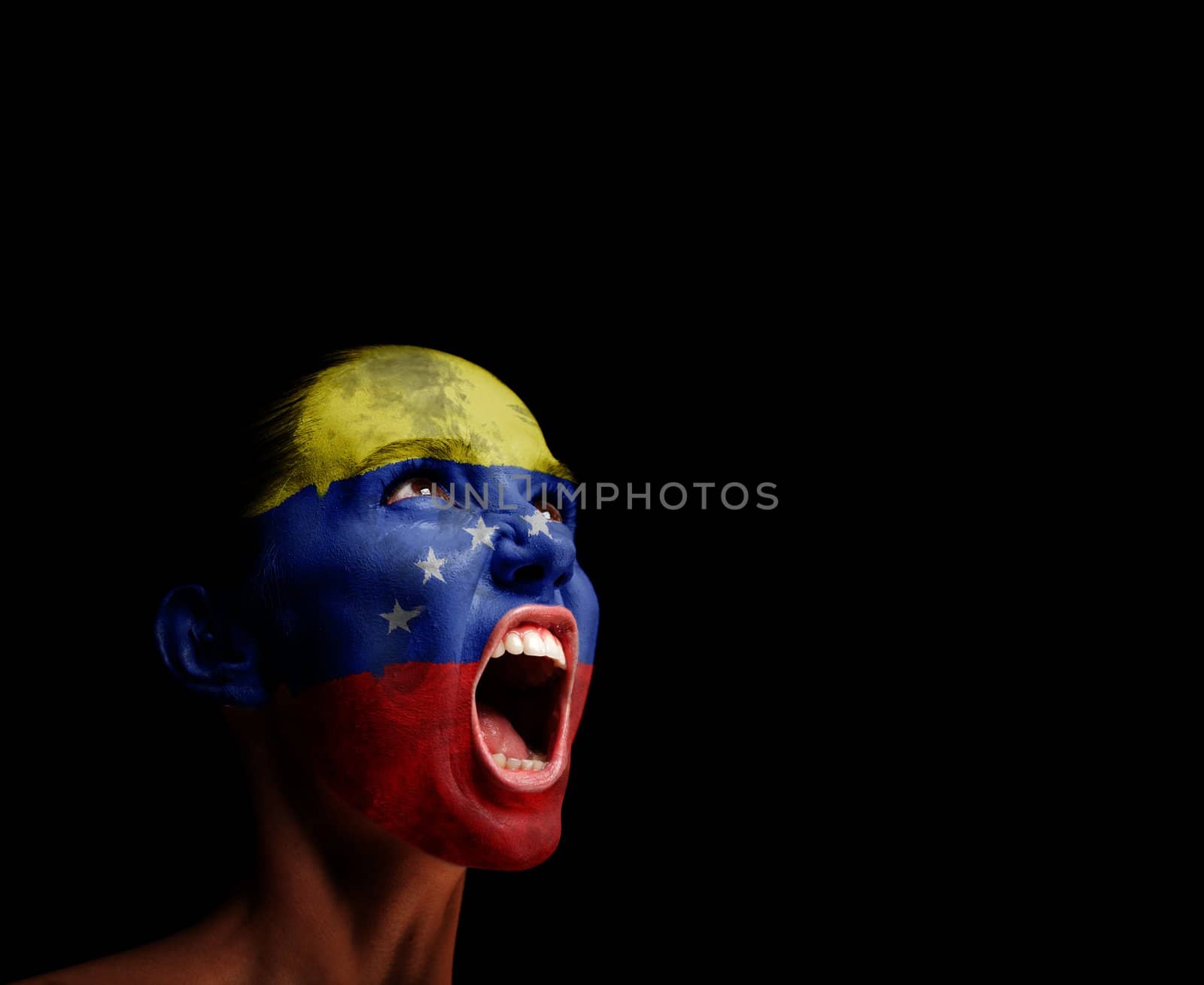 The Venezuelan flag on the face of a screaming woman. concept