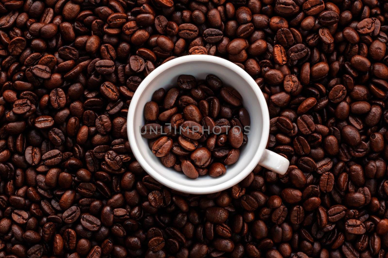 Coffee beans and white espresso cup background