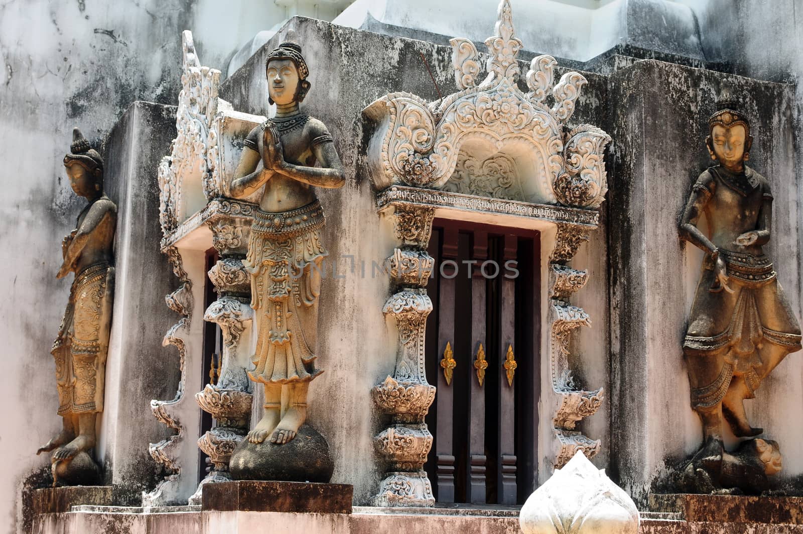 Buddha sculptures in an ancient buddhist wat in Thailand