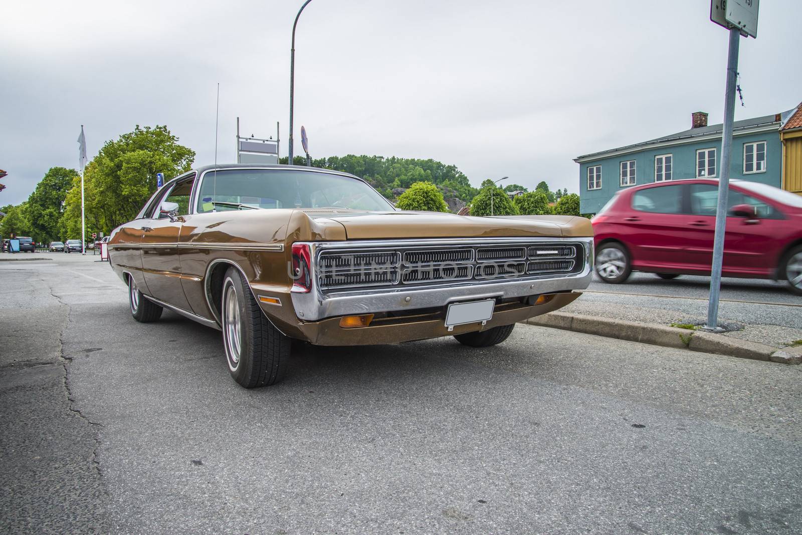 The image is shot at a fish-market in Halden, Norway where there every Wednesday during the summer months are held classic American car show.