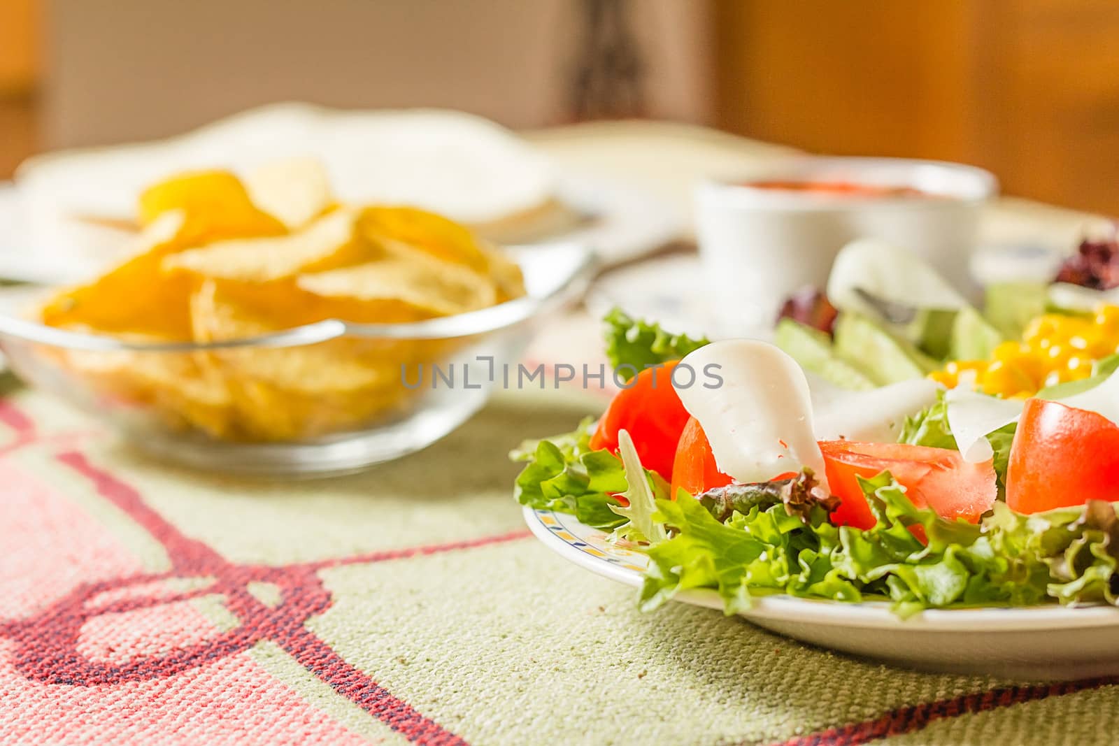 Traditional mexican food with a plate of fresh salad, tortillas, by doble.d