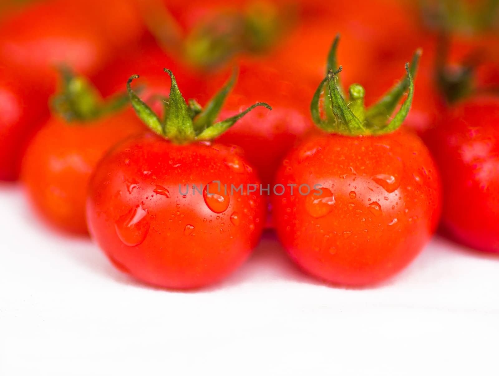 fresh red tomatoes isolated on white