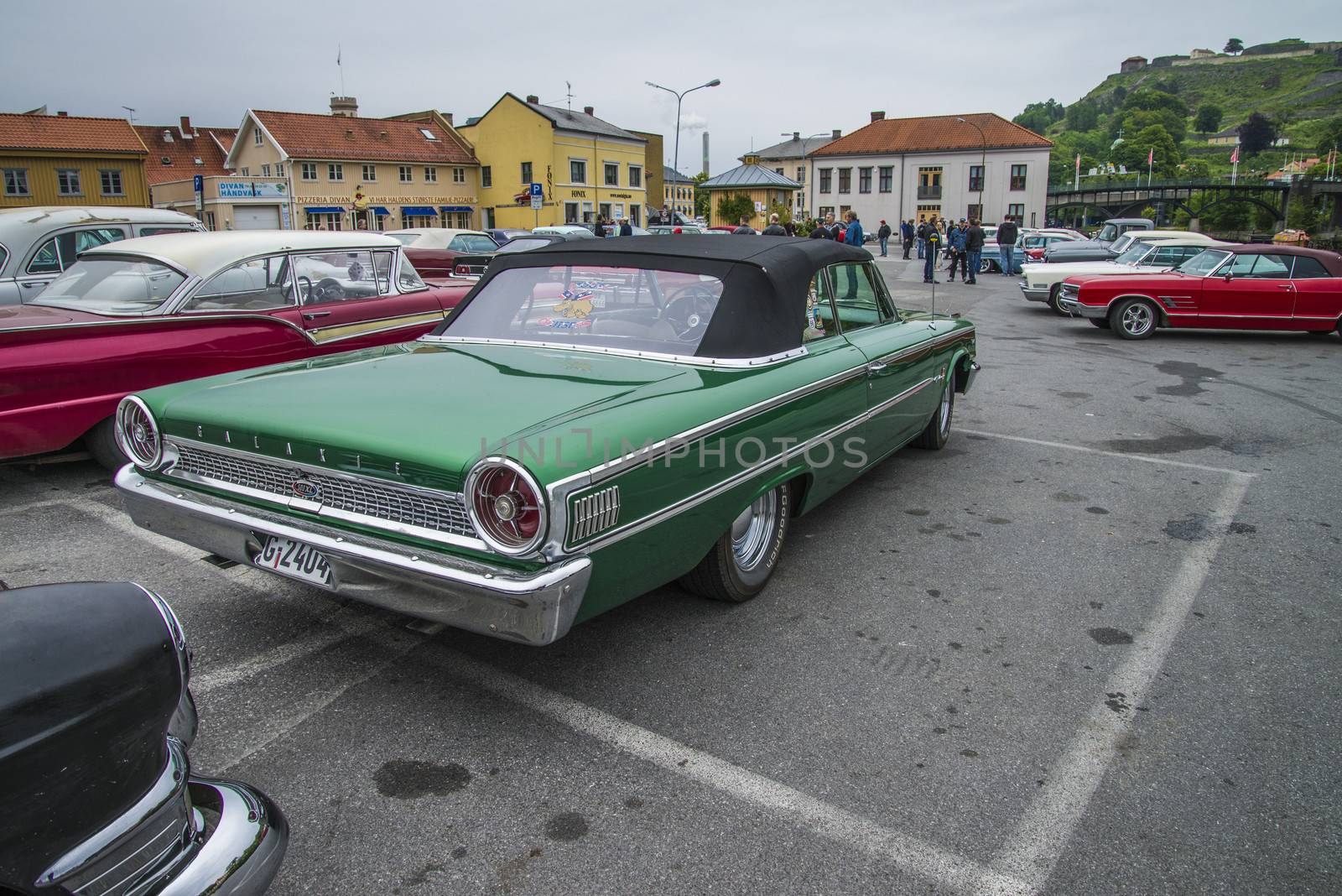 The image is shot at a fish-market in Halden, Norway where there every Wednesday during the summer months are held classic American car show.