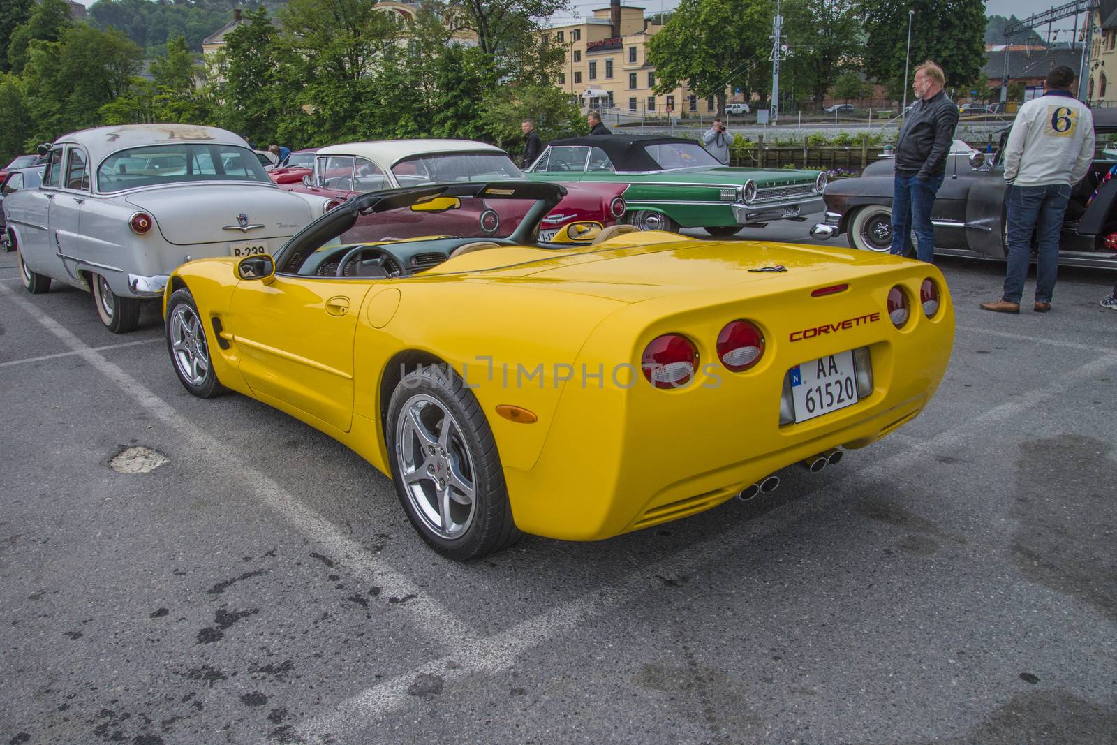 The image is shot at a fish-market in Halden, Norway where there every Wednesday during the summer months are held classic American car show.