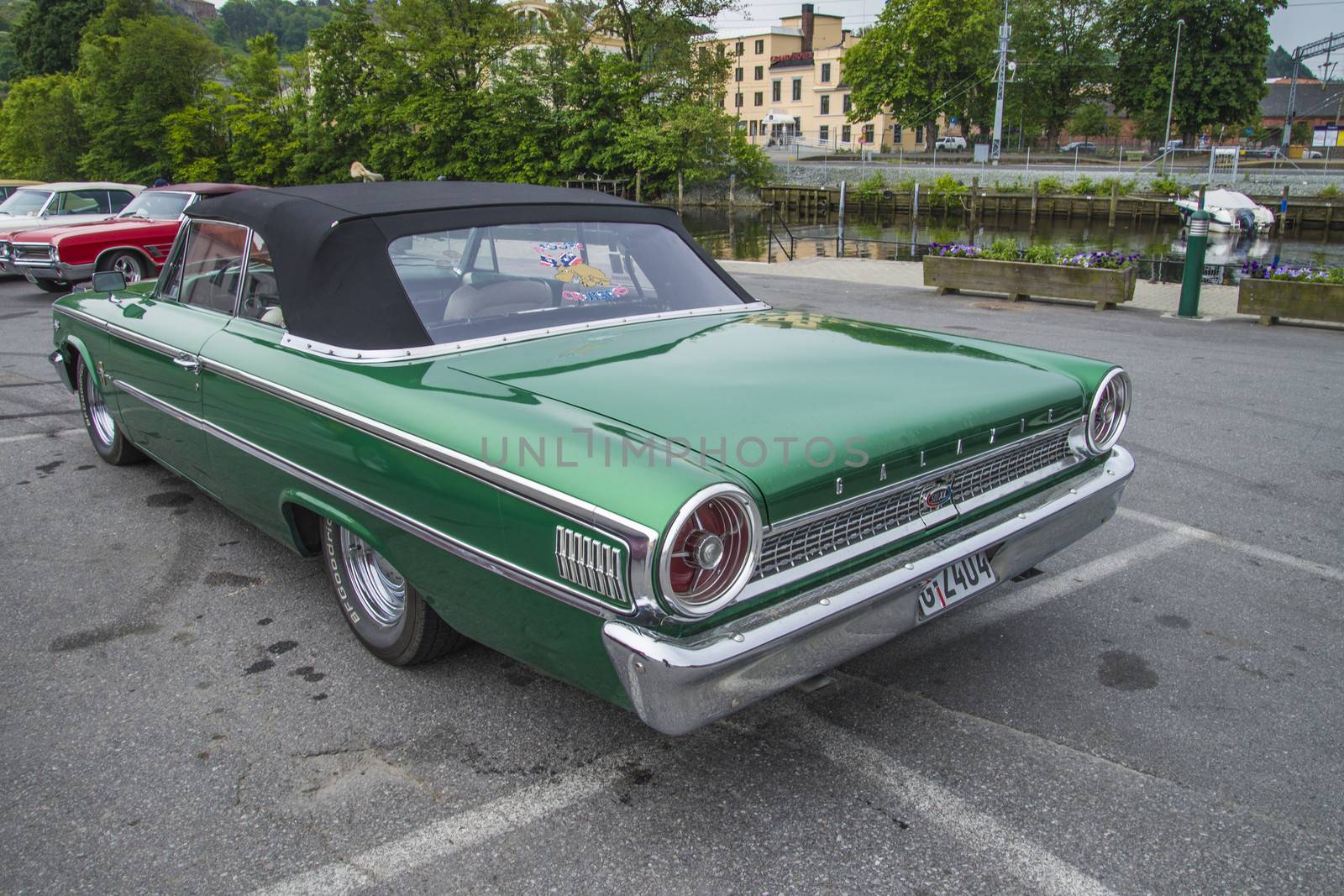 The image is shot at a fish-market in Halden, Norway where there every Wednesday during the summer months are held classic American car show.