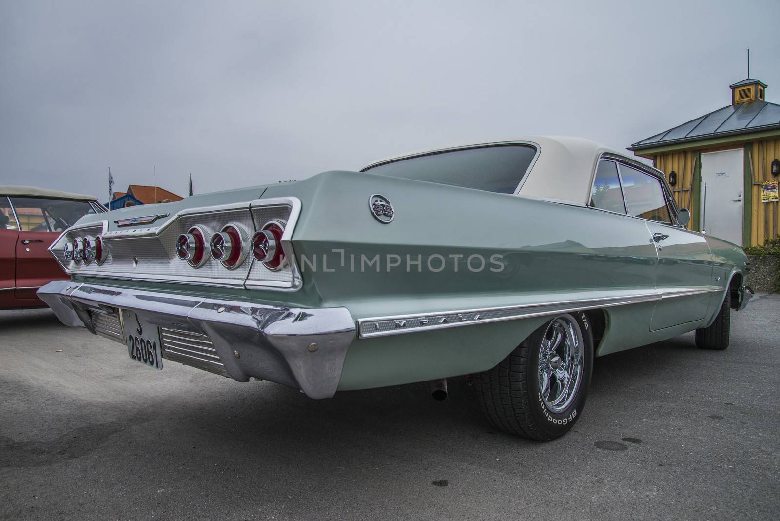 The image is shot at a fish-market in Halden, Norway where there every Wednesday during the summer months are held classic American car show.