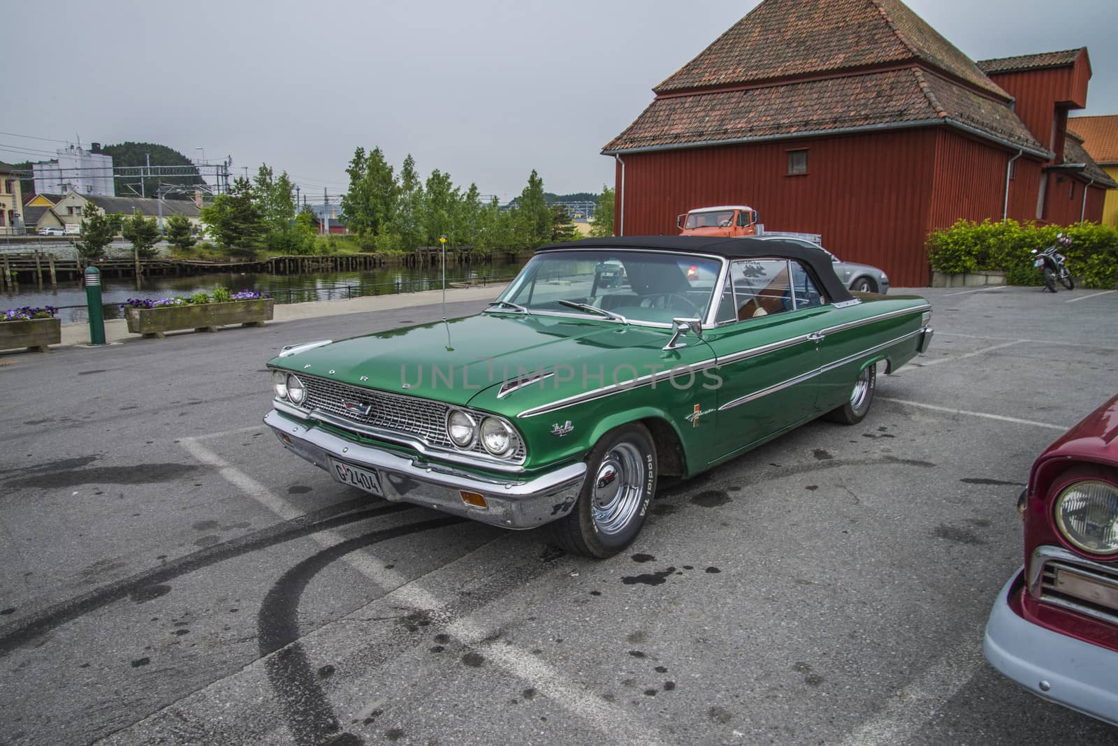 The image is shot at a fish-market in Halden, Norway where there every Wednesday during the summer months are held classic American car show.