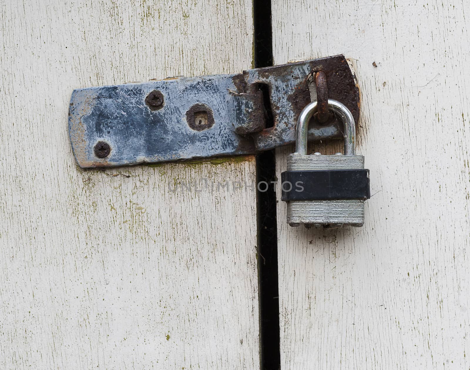 close up of a padlock on wooden doors